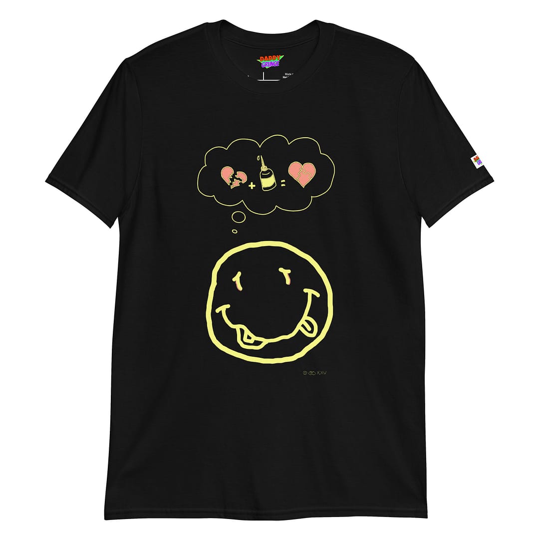 Picture with a black colored shirt with a cartoonish yellow smiley resembling the Nirvana smiley who has a a thought bubble showing a broken heart with a glue squeeze bottle which connects the broken pieces to a repaired heart with the pieces glued together