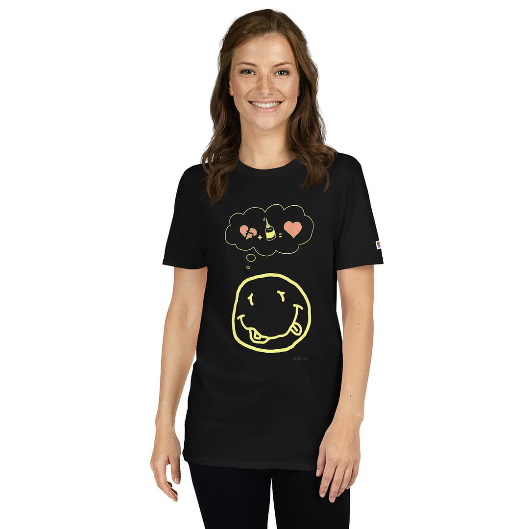 Caucasian girl in a black daddy grunge cartoon shirt with the altered Nirvana smiley and the thought bubble with the glued together heart pieces as a motive.