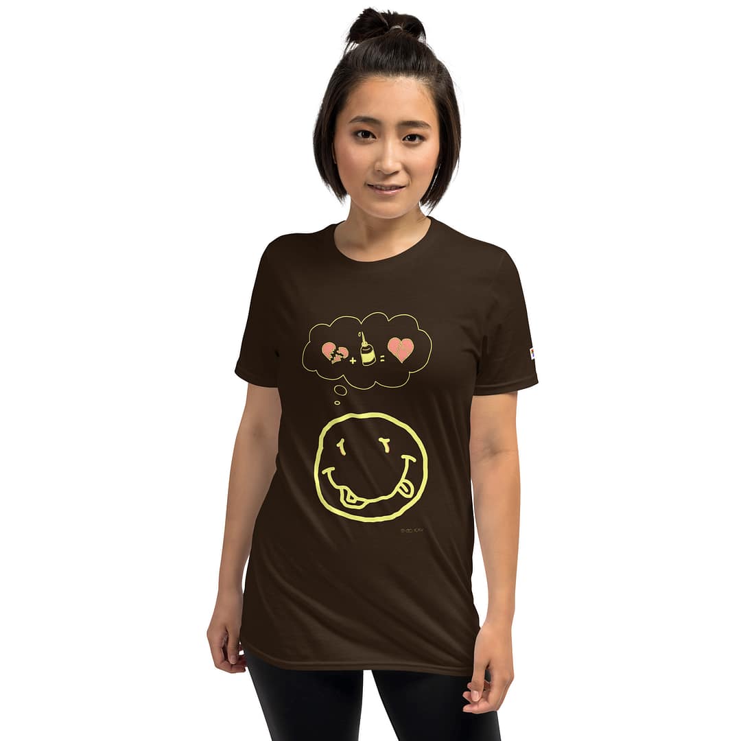 Asian girl in a dark brown colored daddy grunge cartoon shirt with the altered Nirvana smiley and the thought bubble with the glued together heart pieces as a motive.