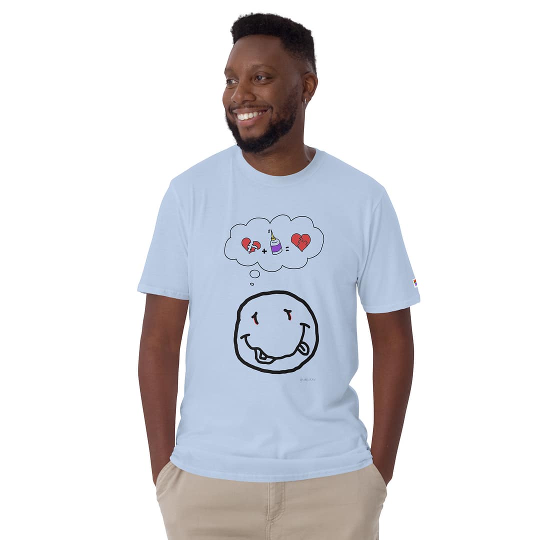 Smiling black guy looking to the right wearing a light blue daddy grunge cartoon shirt with the altered Nirvana smiley and the thought bubble with the glued together heart pieces as a motive.