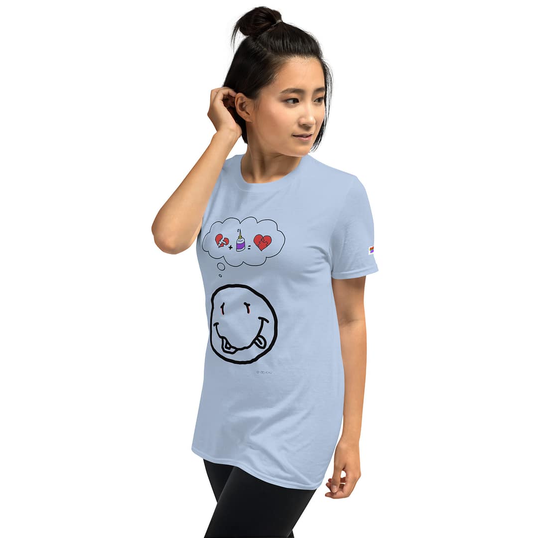 Asian girl in a light blue daddy grunge cartoon shirt with the altered Nirvana smiley and the thought bubble with the glued together heart pieces as a motive.