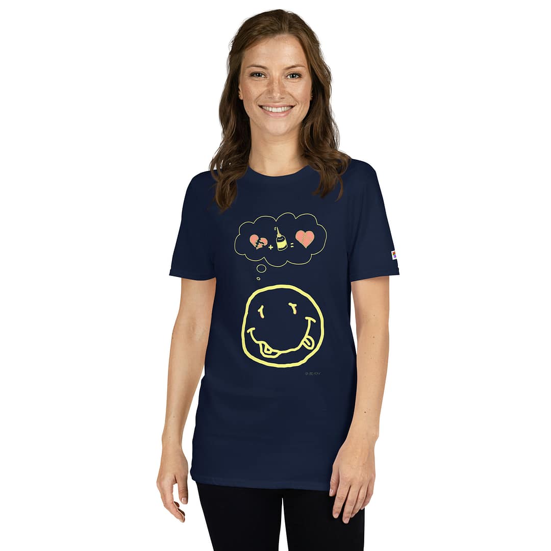 Caucassian girl in a dark navy blue daddy grunge cartoon shirt with the altered Nirvana smiley and the thought bubble with the glued together heart pieces as a motive.