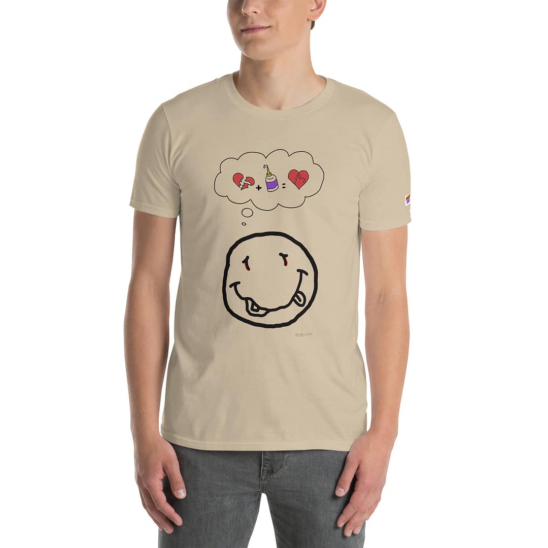 Caucassian guy in a sand-colored daddy grunge cartoon shirt with the altered Nirvana smiley and the thought bubble with the glued together heart pieces as a motive. Face is halfway cut off.