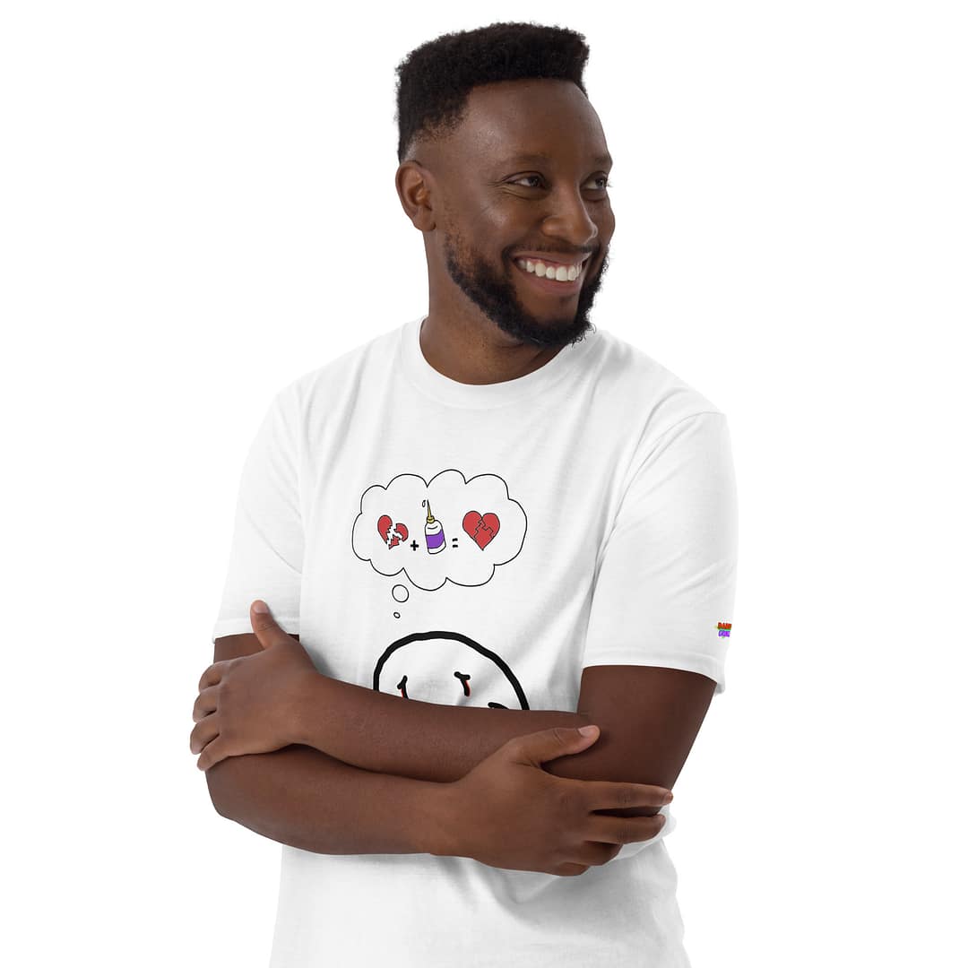 Black guy crossing his arms over a white brown daddy grunge cartoon shirt with the altered Nirvana smiley and the thought bubble with the glued together heart pieces as a motive.
