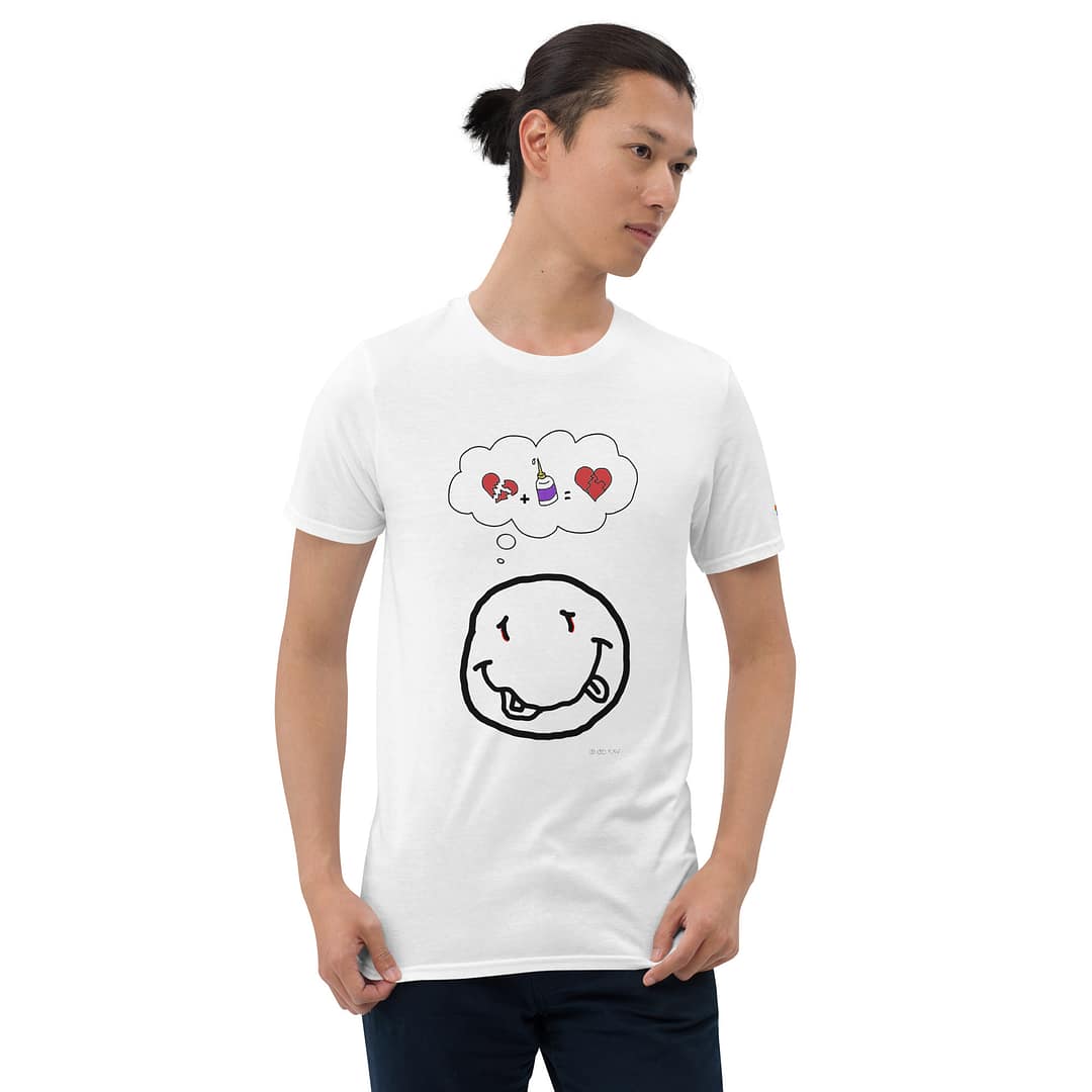 Skinny Asian guy in a white daddy grunge cartoon shirt with the altered Nirvana smiley and the thought bubble with the glued together heart pieces as a motive.